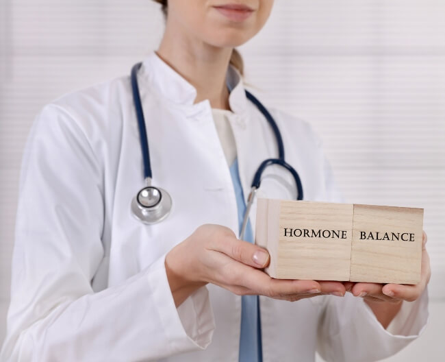 Doctor explaining the importance of balancing female hormones naturally in San Diego