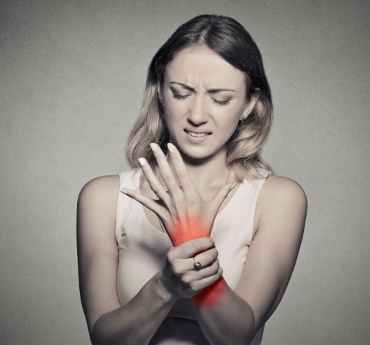 Woman suffering with a severe Diabetic nerve pain in her hand